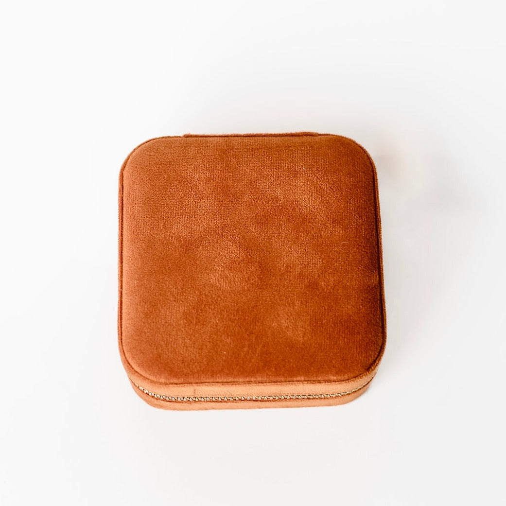 The outside of a burnt orange jewelry case.
