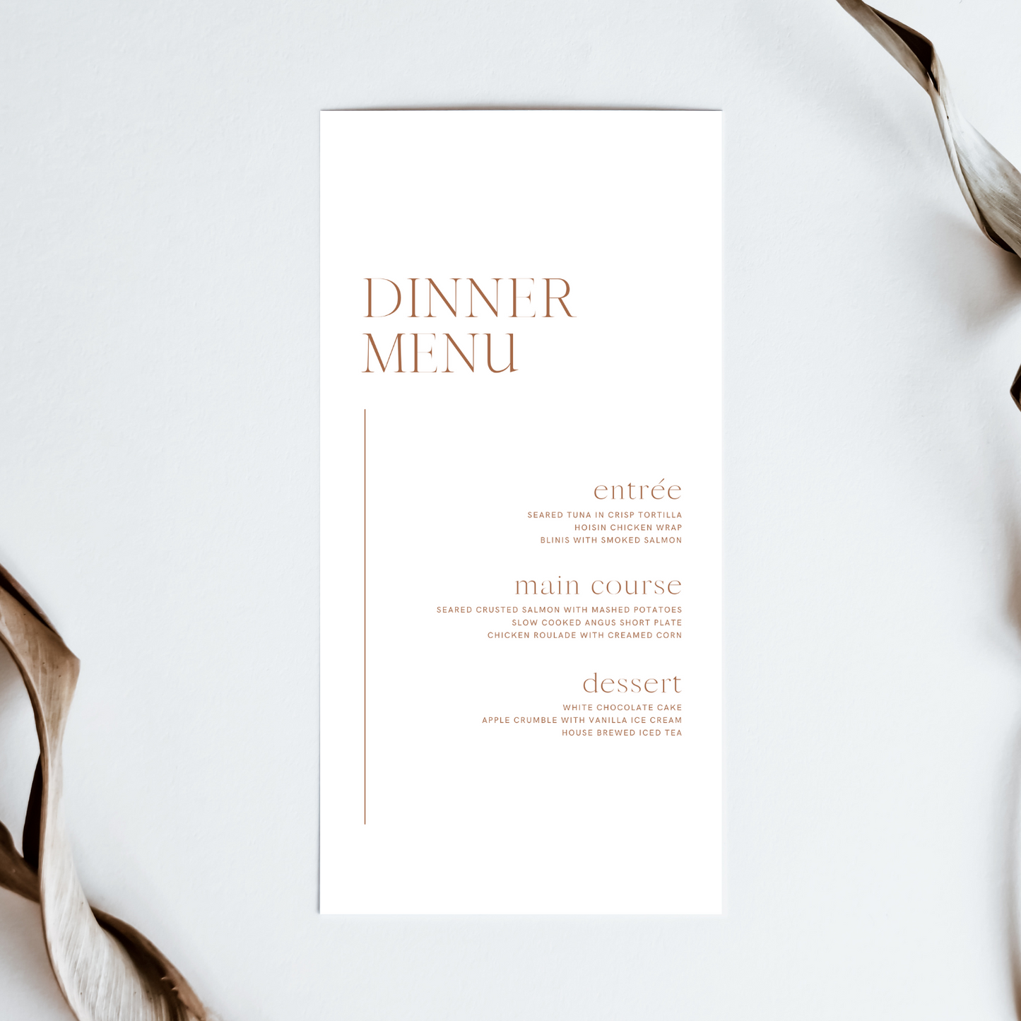 A minimalist, white wedding menu lays on an off-white background.