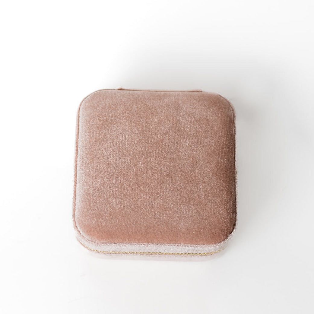 The outside of a blush-coloured jewelry case.