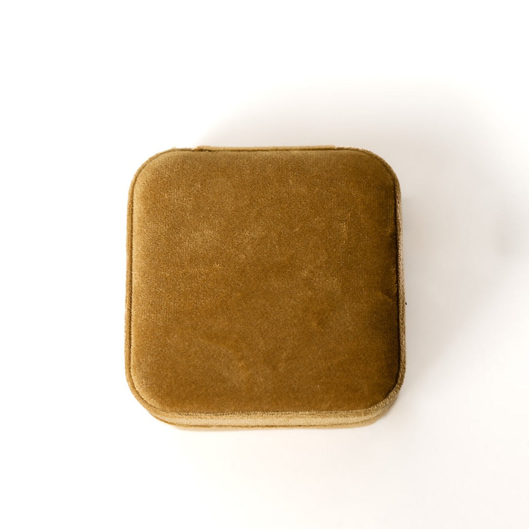 The outside of a mustard-coloured jewelry case.