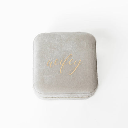 The outside of an ivory jewelry case with the word "wifey" written across the middle.