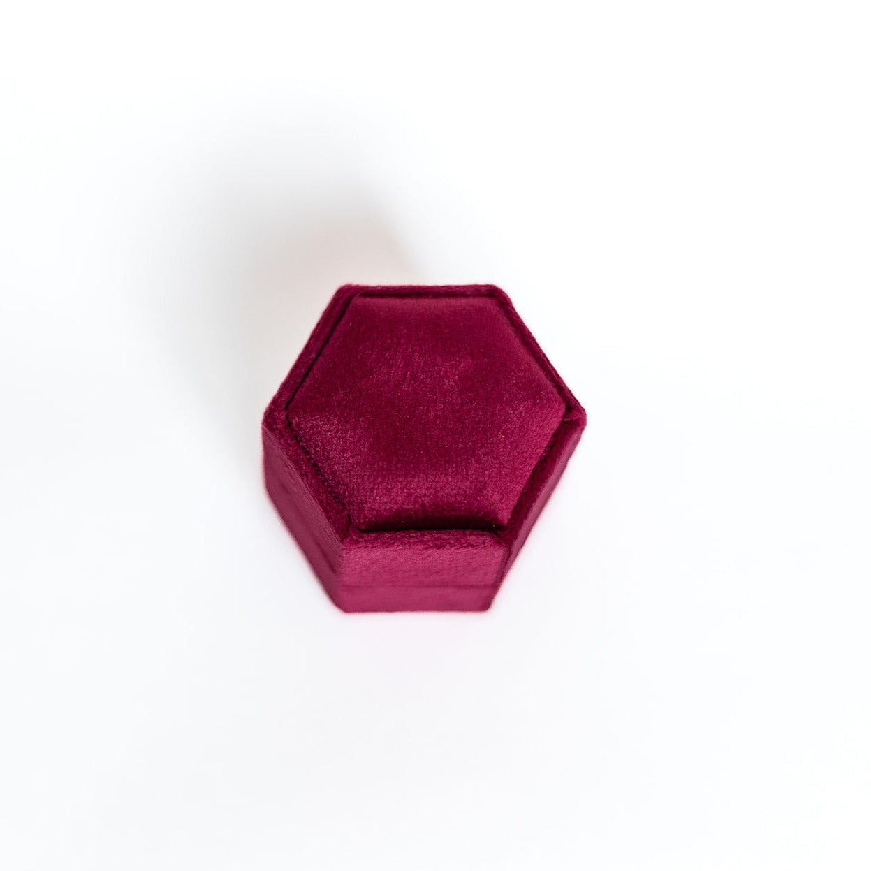 The outside of a raspberry hexagon ring box.