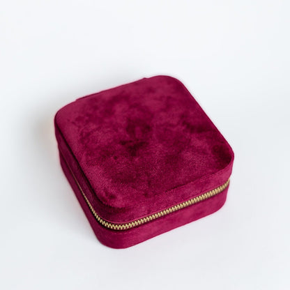 The outside of a raspberry-coloured jewelry case.
