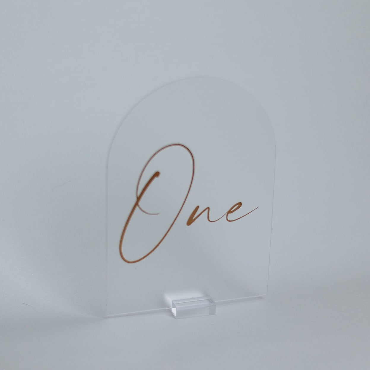 A frosted arch table number on a clear acrylic base.