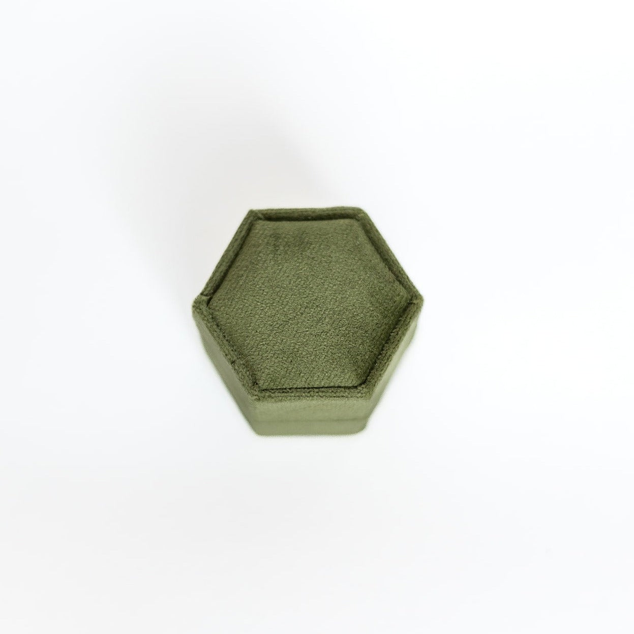 The outside of an olive-coloured hexagon ring box.