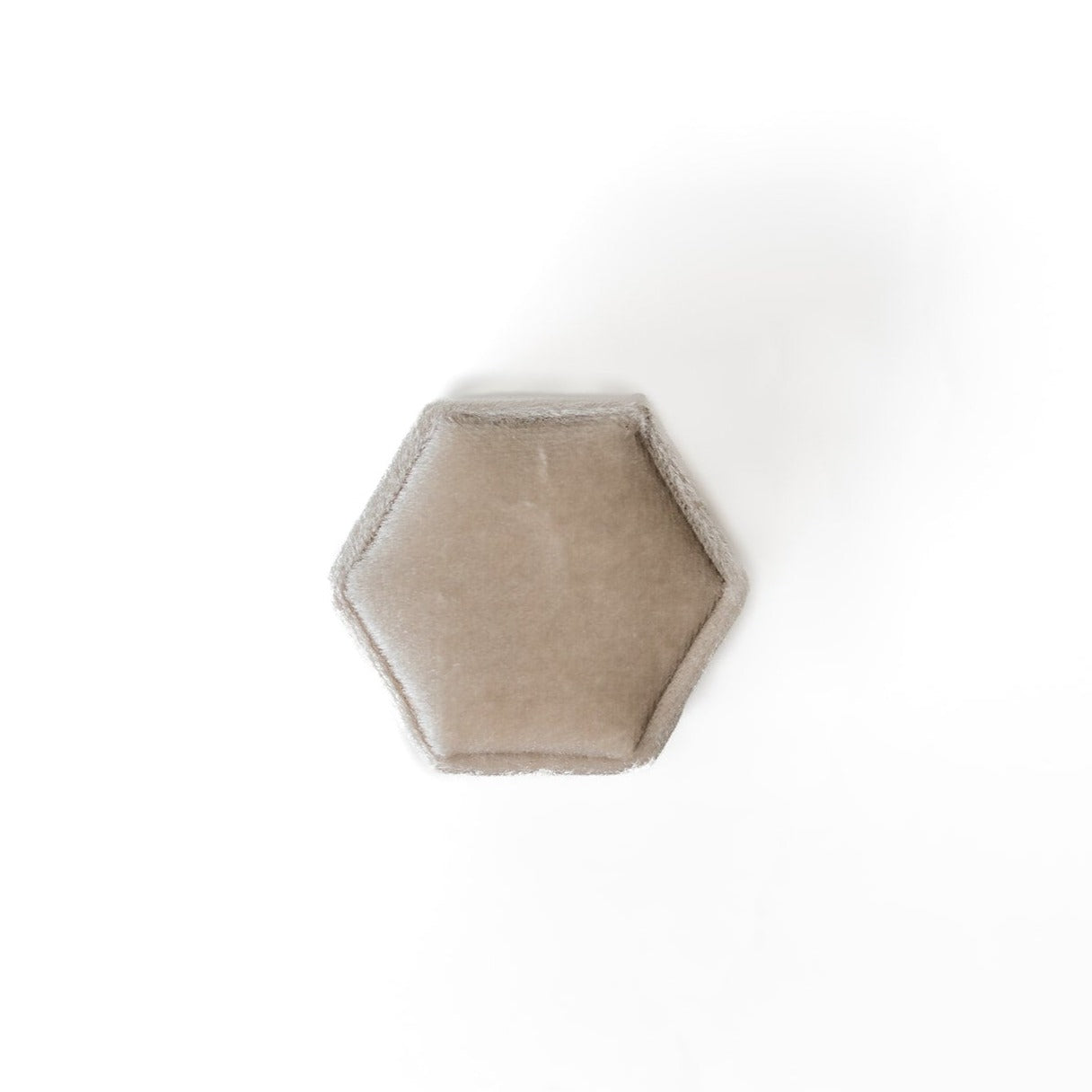 The outside of an ivory hexagon ring box.