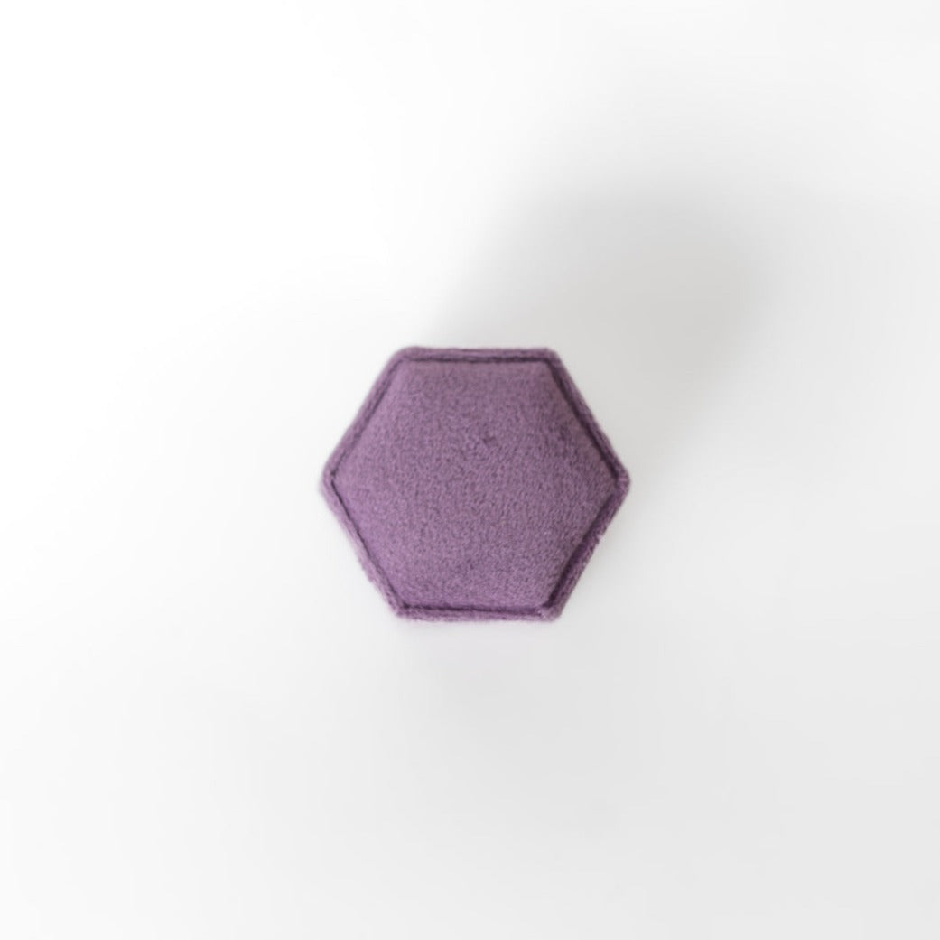 The outside of a mauve hexagon ring box.