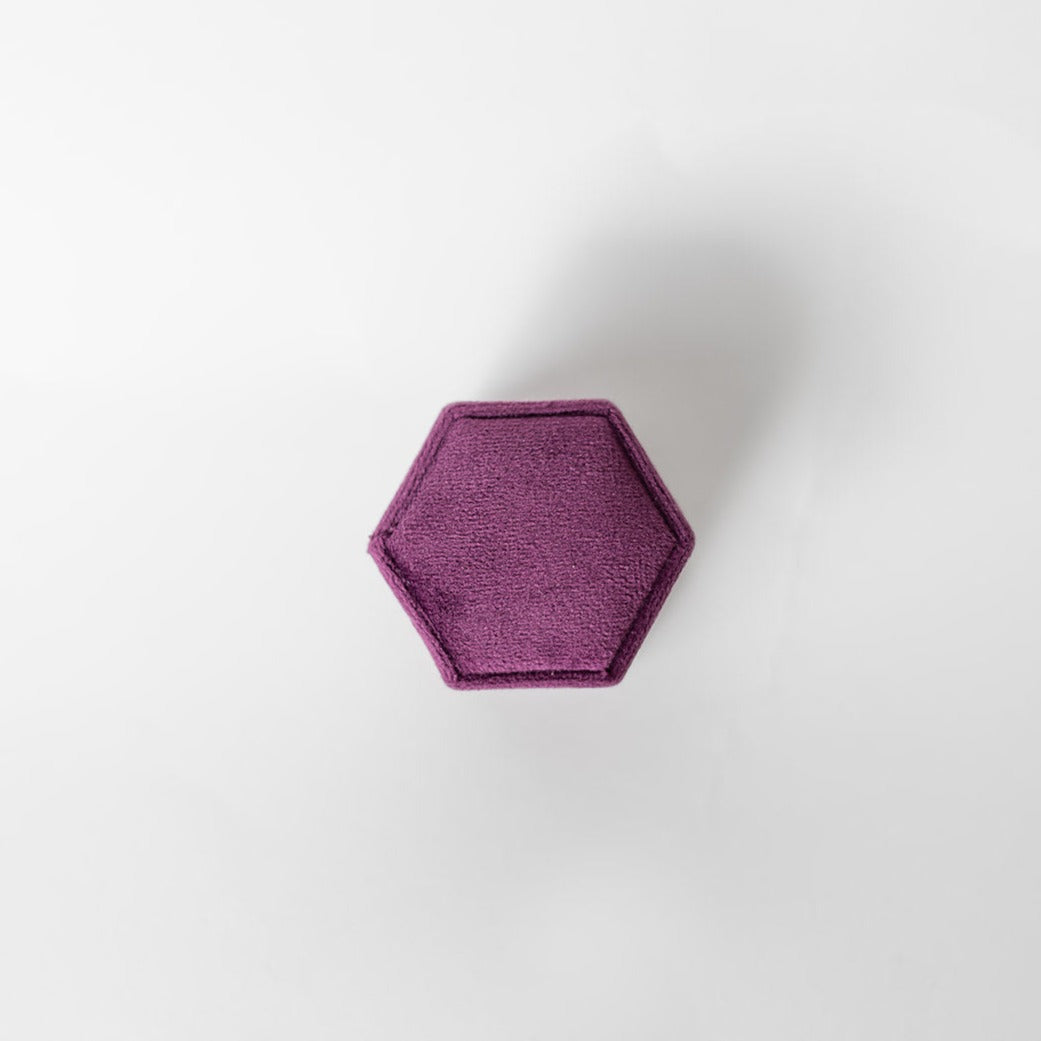 The outside of a plum-coloured hexagon ring box.