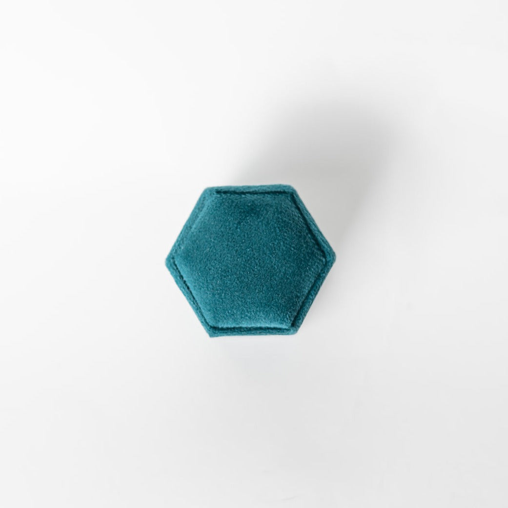 The outside of a teal hexagon ring box.