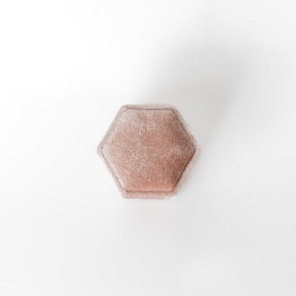The outside of a blush-coloured hexagon ring box.