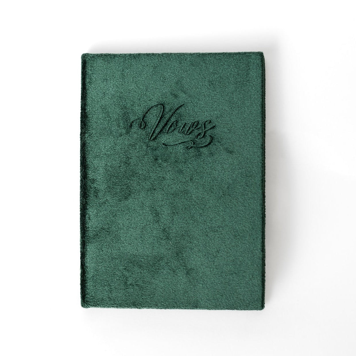 An emerald vow book with the word "Vows" embossed on the front cover.