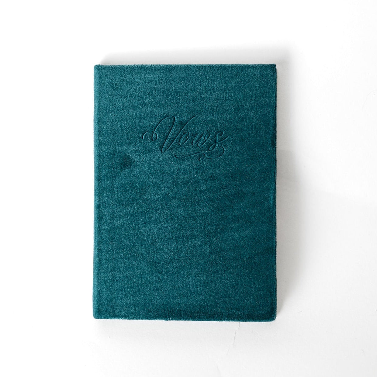 A teal vow book with the word "Vows" embossed on the front cover.